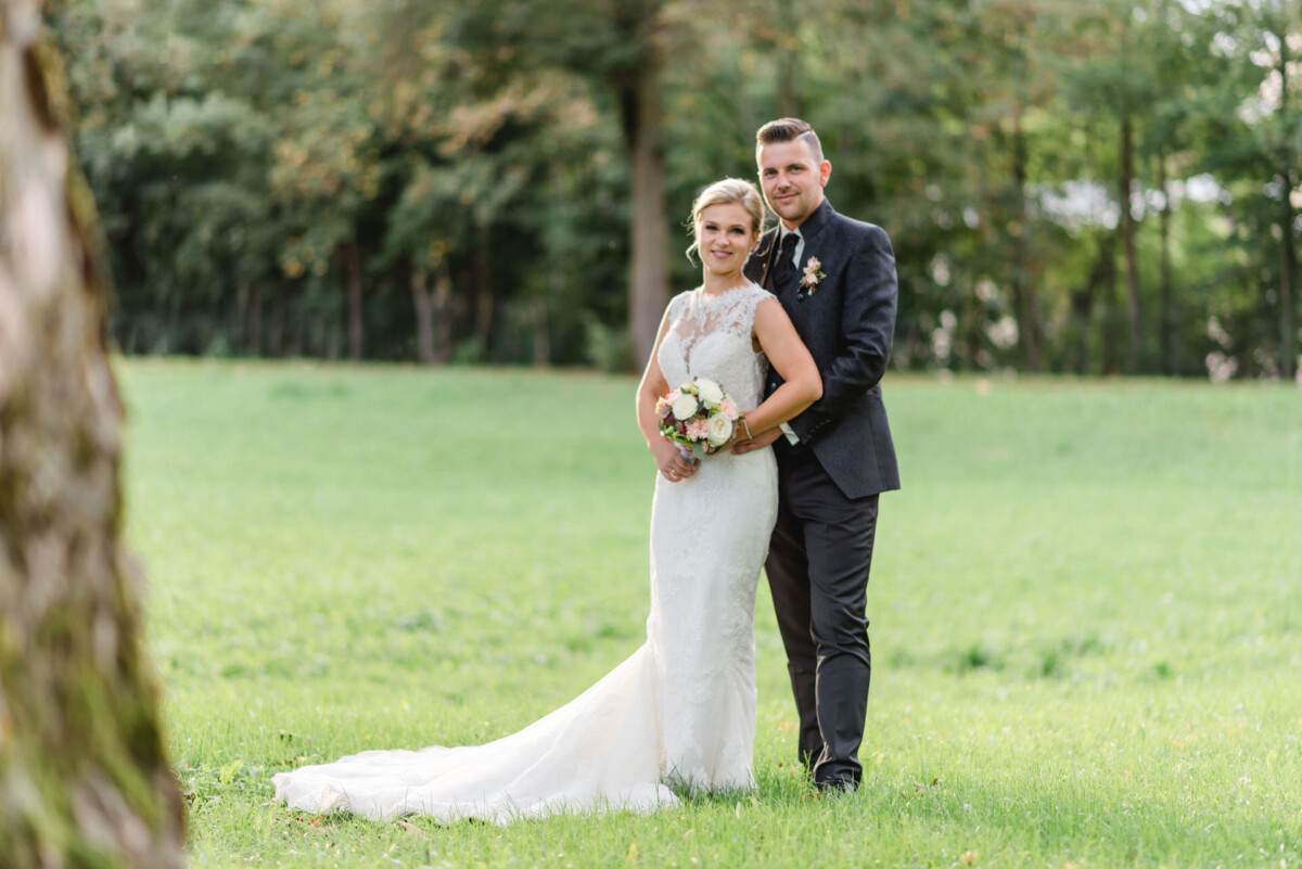 Janina_Daniel_Ettringen_00025 Eine Braut und ein Bräutigam posieren für ein Bild in einem Feld.