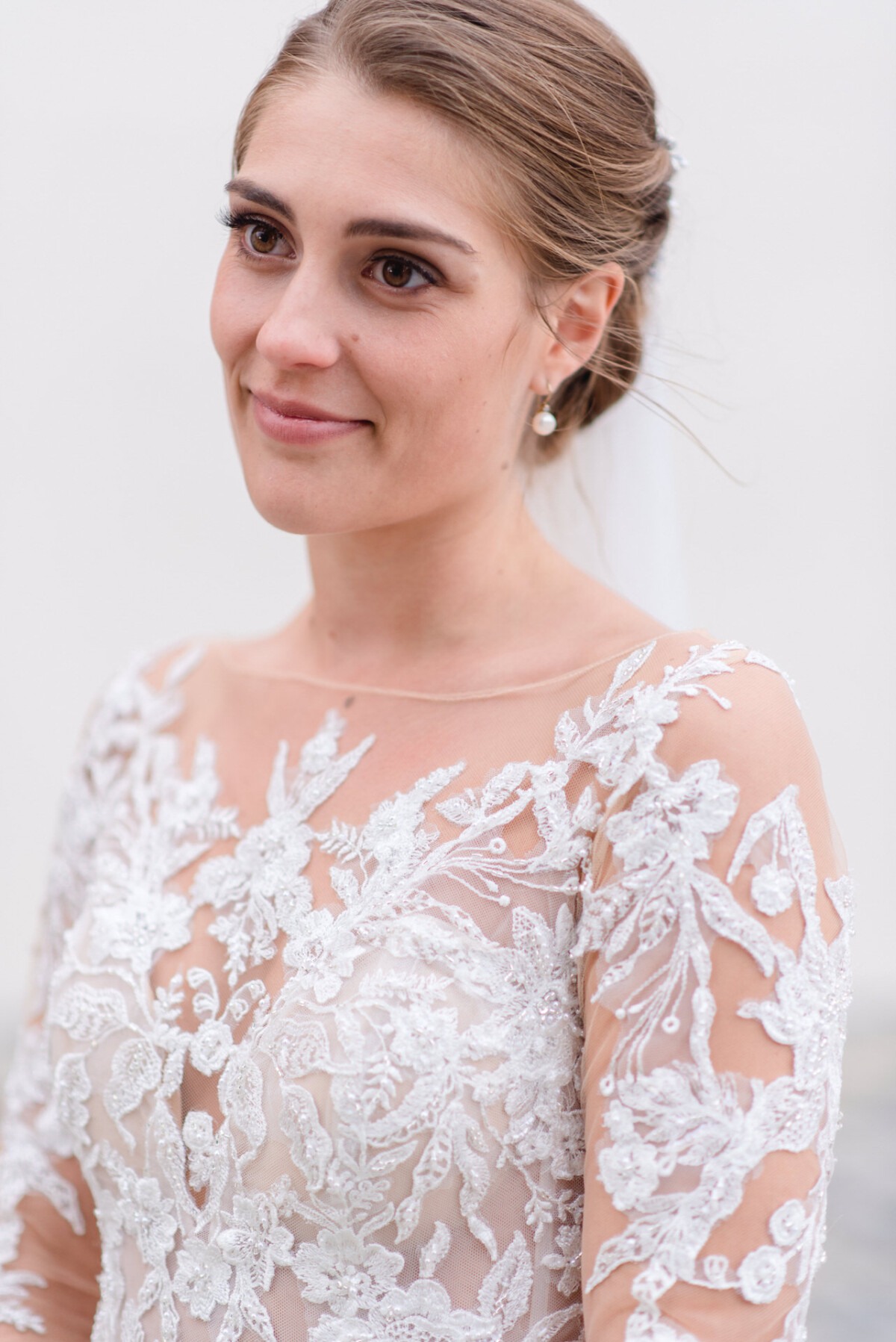 Sophia_Riccardo_Ammersee_00035 Eine Frau in einem Hochzeitskleid schaut in die Kamera.