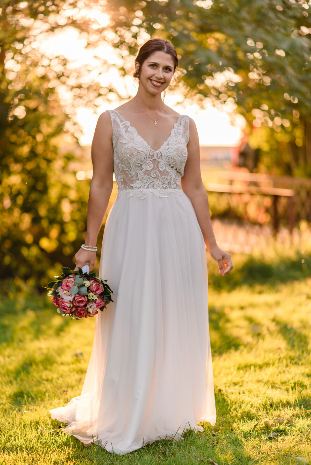 R_M_Bobingen_Langerringen_Hochzeit_00731_web eine Frau in einem Hochzeitskleid, die einen Blumenstrauß hält.