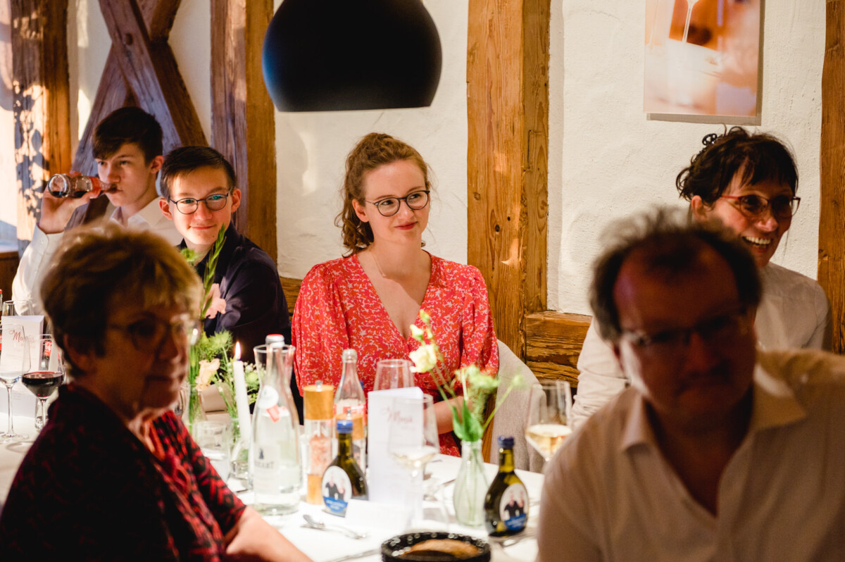 eine Gruppe von Menschen, die um einen Tisch sitzen.