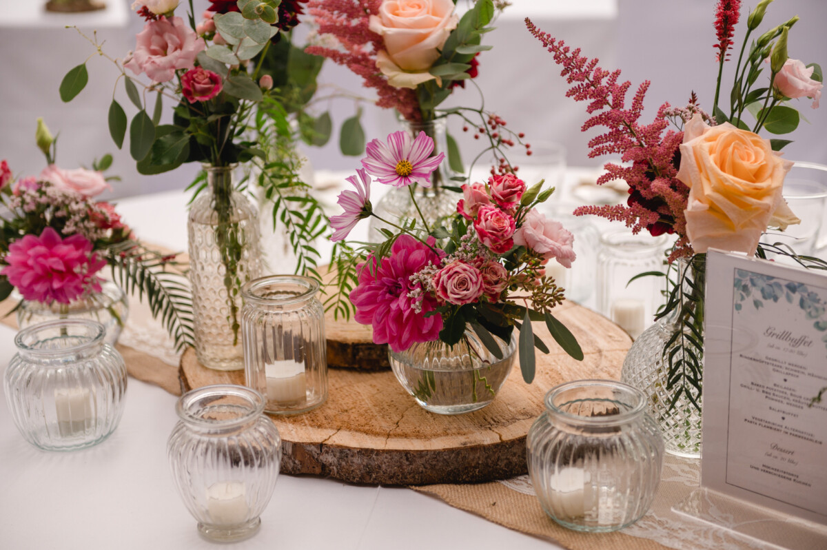 ein Tisch mit Vasen gefüllt mit Blumen.