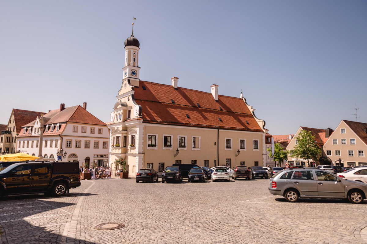Auf einer Kopfsteinpflasterstraße geparkte Autos.